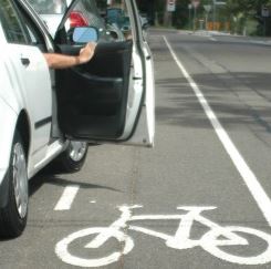 Car door opens as bicycle approaches